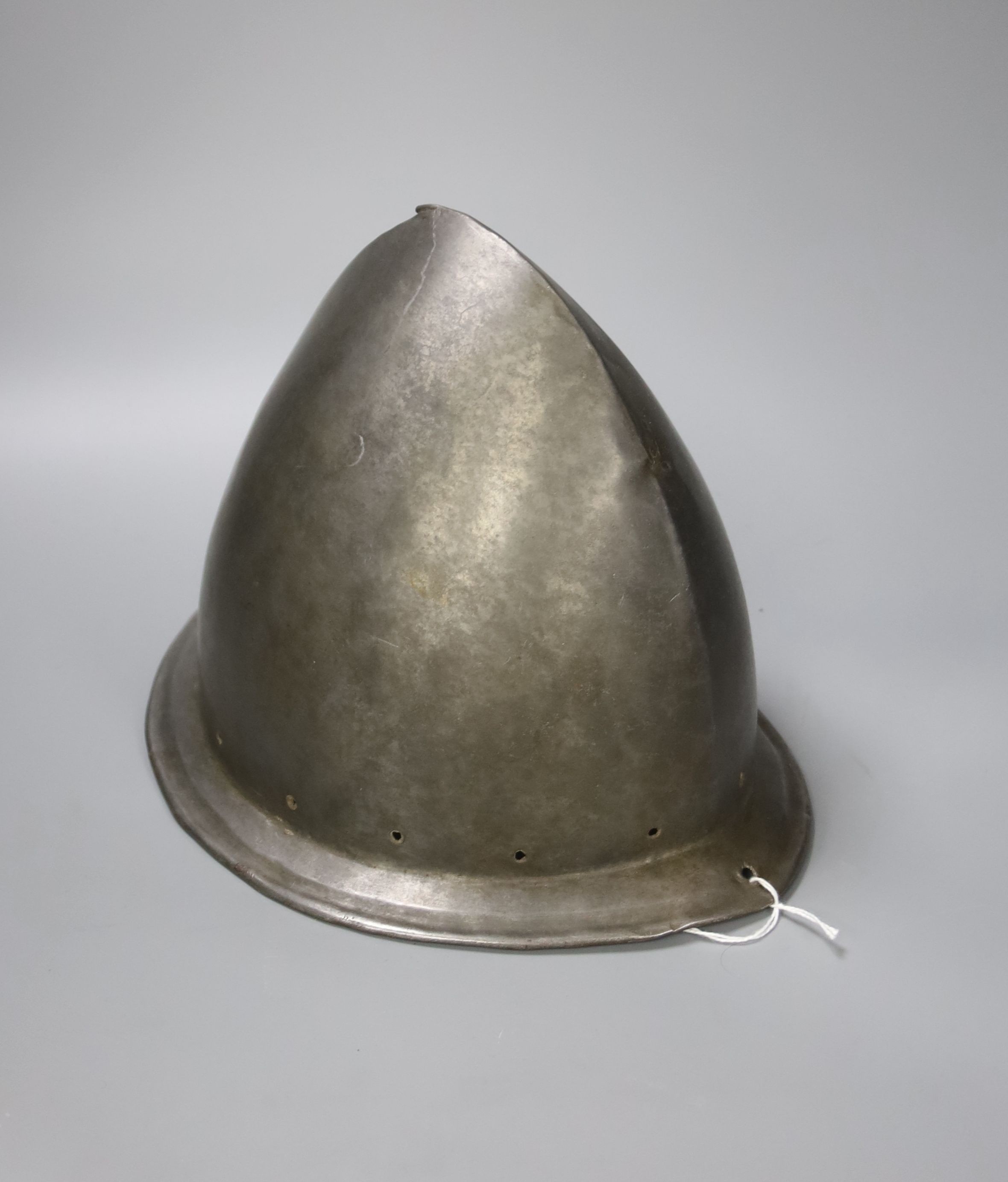 A good Italian Infantry Helmet Cabasset c.1580, polished steel raised from a single plate, medial ridge with pear stalk finial, borders pierced for rosettes, flared brim with turned over edge. Height 22cms.